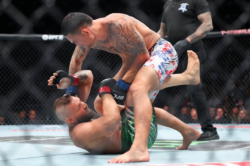 Max Holloway lands a punch on Conor McGregor during their fight in Las Vegas. Photograph: Ian Maule/Getty