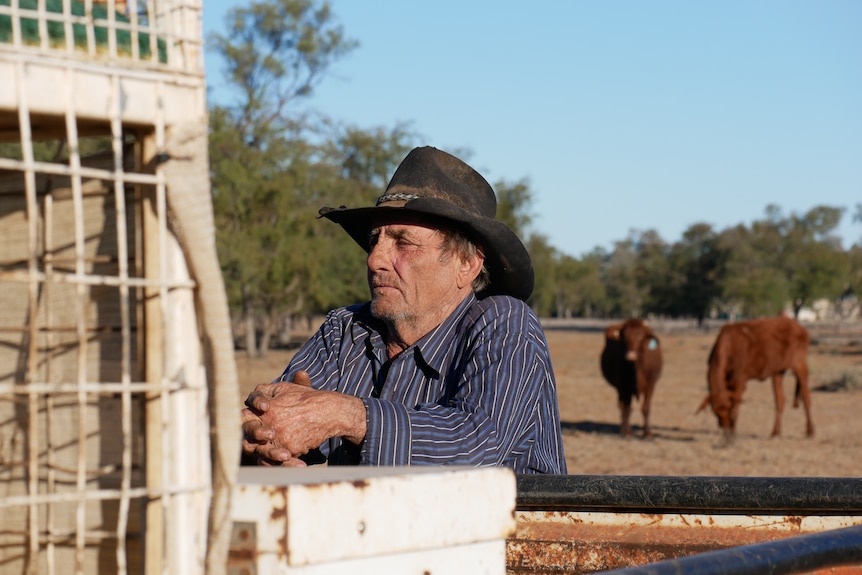 Keith Allwood leans against a car in a paddock