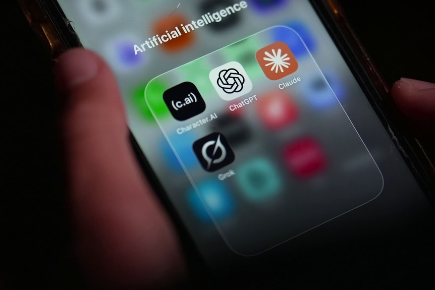 A person holding an iPhone with Character.aI, ChatGPT, Claude and Grok chatbot apps on screen.