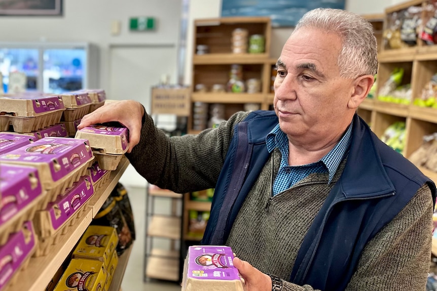 Man sorting eggs in a shop.