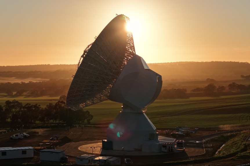 A single large deep space antenna pictured at sunset.