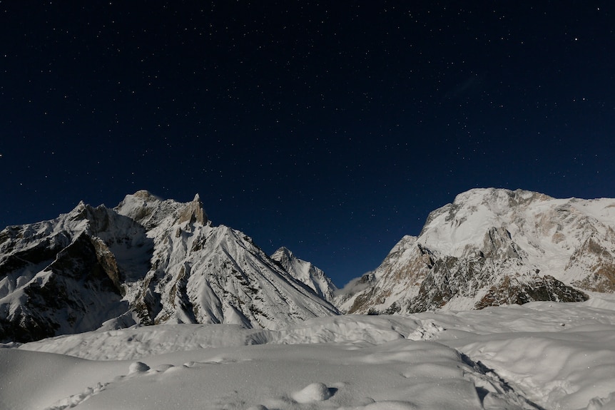 Snow-covered mountains at night time