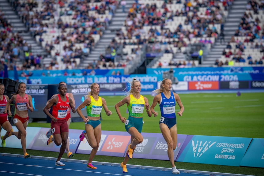 Athletes on a track in a stadium