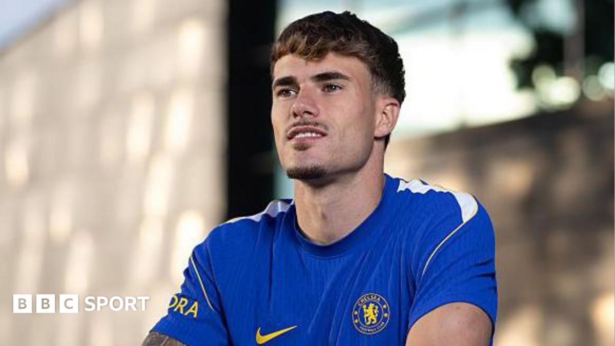 Pep Chavarria looks past the camera while wearing a Chelsea shirt