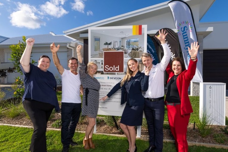 Group of people in front of a home