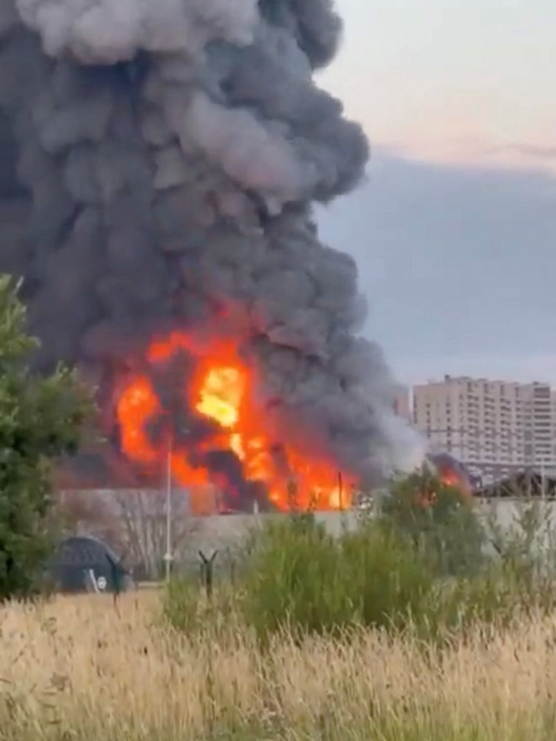 A large amount of flames and smoke rise from a building.