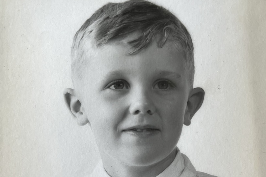 Black and white aged portrait of a young boy. 