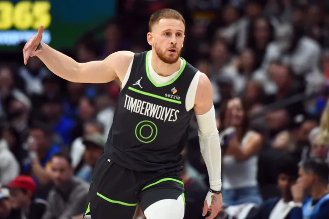 Apr 18, 2026; Denver, Colorado, USA; Minnesota Timberwolves guard Donte DiVincenzo (0) celebrates after a three-pointer during the second half against the Denver Nuggets in game one of the first round of the 2026 NBA Playoffs at Ball Arena. Mandatory Credit: Christopher Hanewinckel-Imagn Images