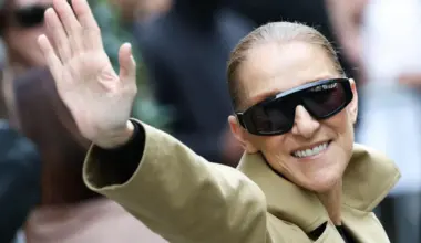 Canadian singer Celine Dion acknowledges fans as she arrives at Hotel Le Royal Monceau in Paris on Aug 28.