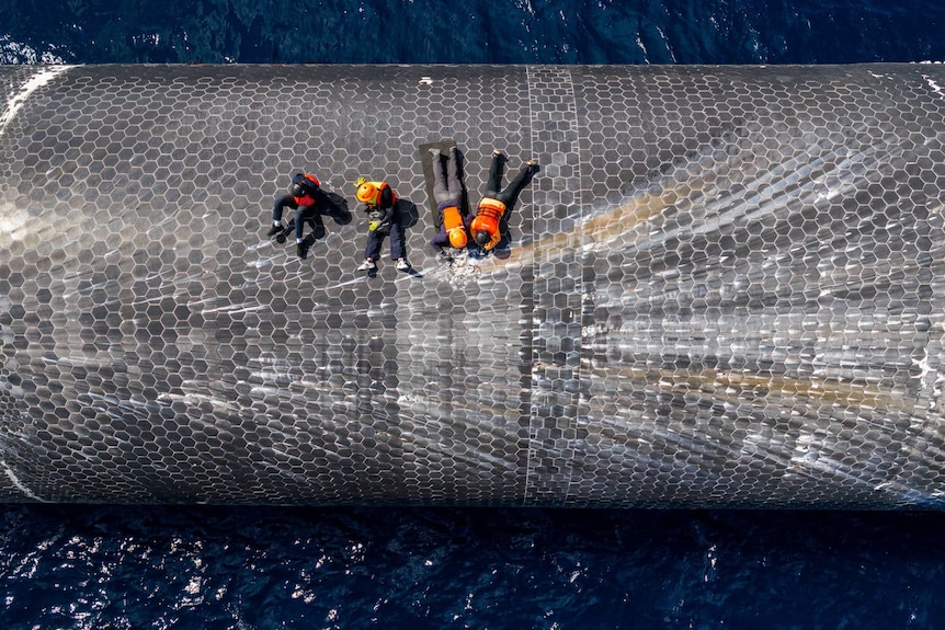 An aerial shot of crews on top of a rocket