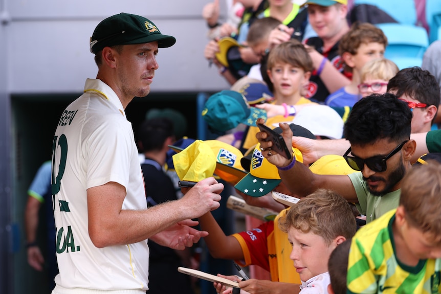 Cameron Green signs autographs after a Test against Bangladesh in Darwin.