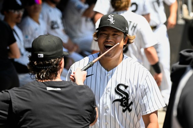 Chicago White Sox first baseman Munetaka Murakami reacts as teammate Mike Vasil waves a magic wand over him in the dugout before the team's baseball game against the Minnesota Twins, Thursday, May 28, 2026, in Chicago. (AP Photo/Matt Marton)