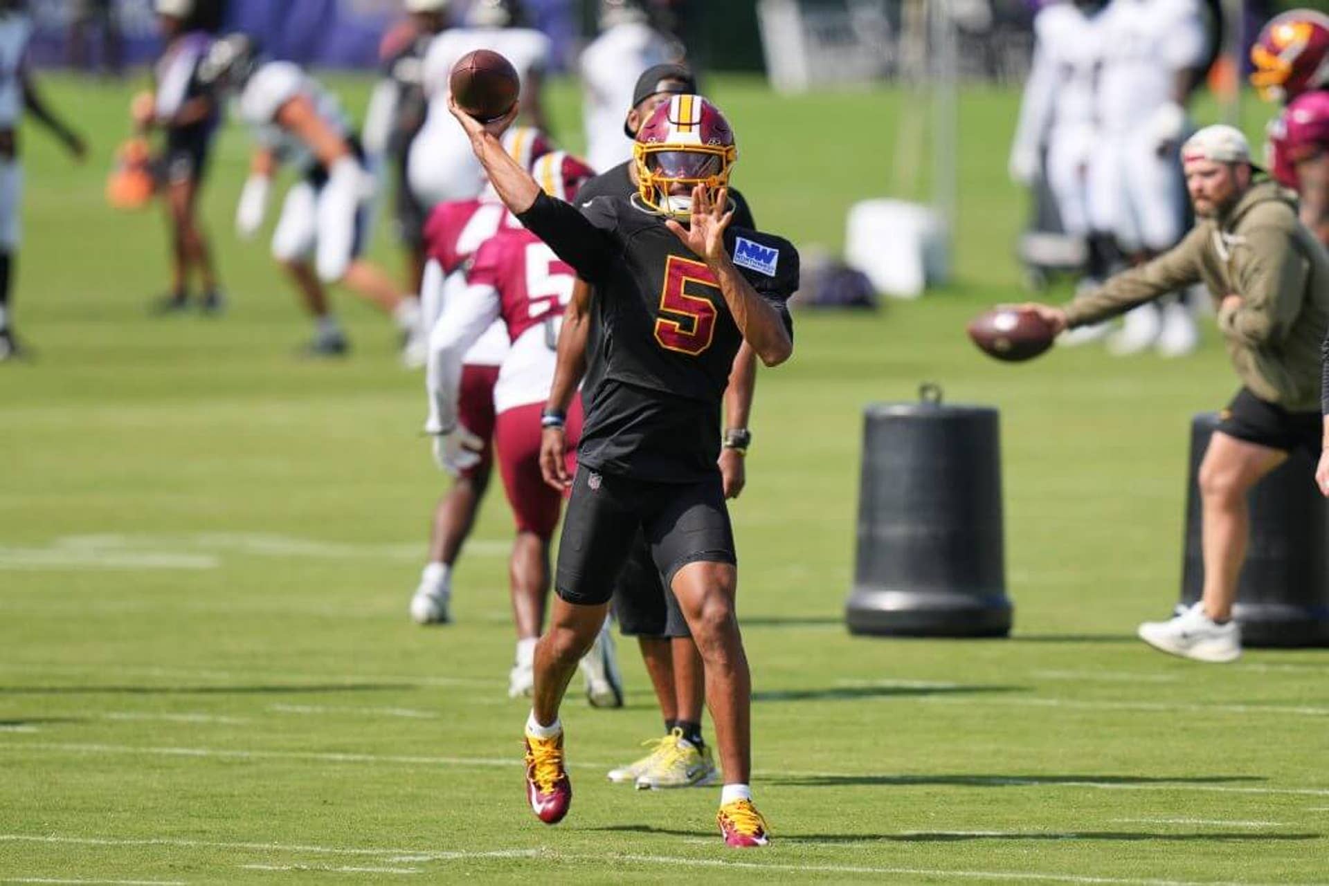 Washington Commanders quarterback Jayden Daniels throws a pass at training camp.