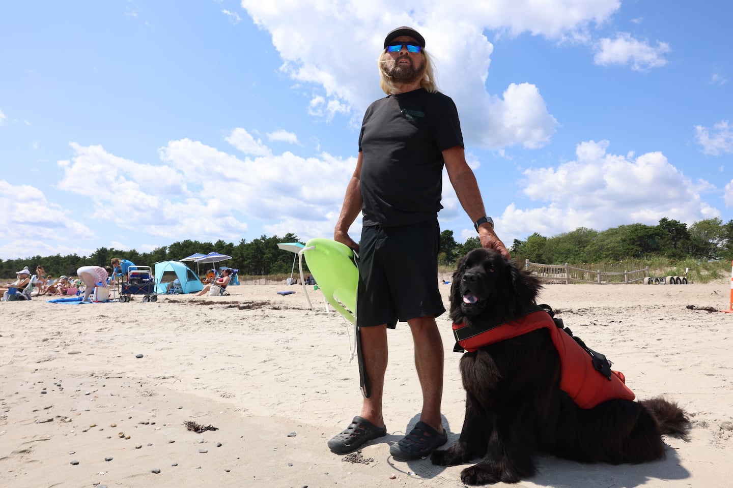 Lifeguard Greg Wilfert scans Scarborough Beach for sharks with his dog Beacon by his side.