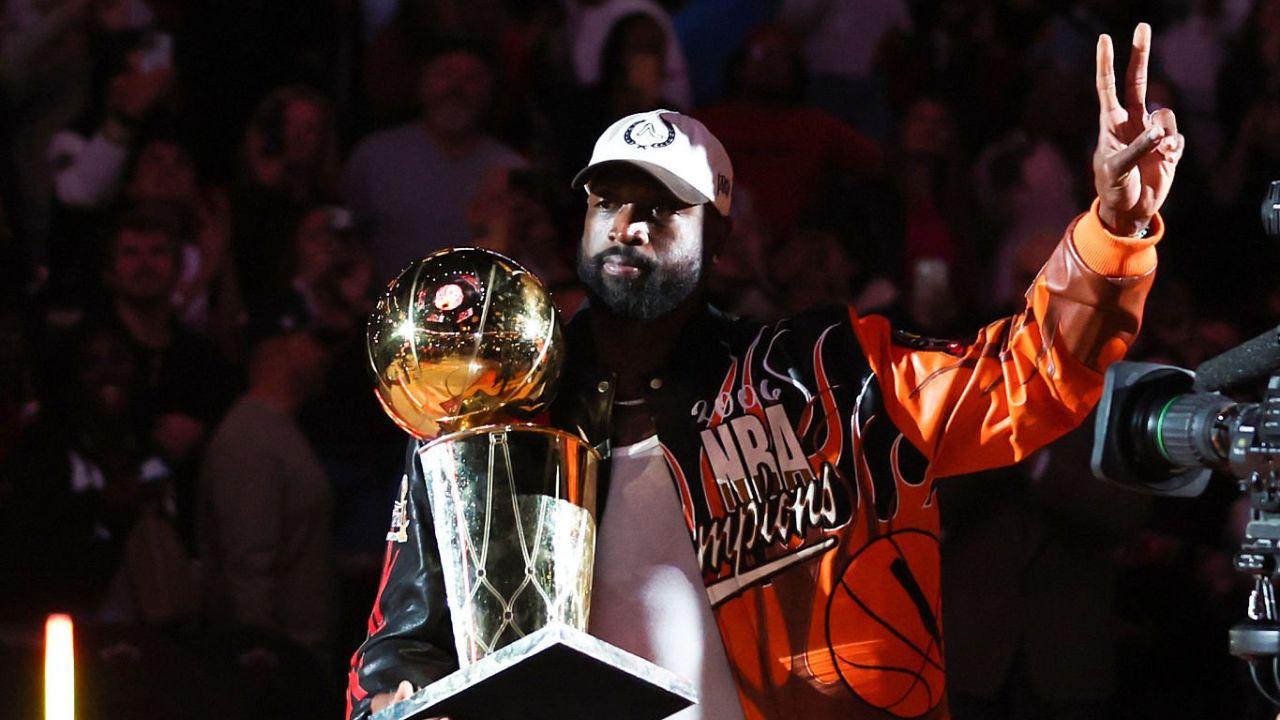 MIAMI, FLORIDA - FEBRUARY 03: Dwyane Wade carries the Larry O'Brien trophy during a ceremony to mark the 20th anniversary of the Miami Heat's 2006 NBA Finals title at halftime of a game between the Heat and the Atlanta Hawks at Kaseya Center on February 03, 2026 in Miami, Florida. (Photo by Megan Briggs/Getty Images)