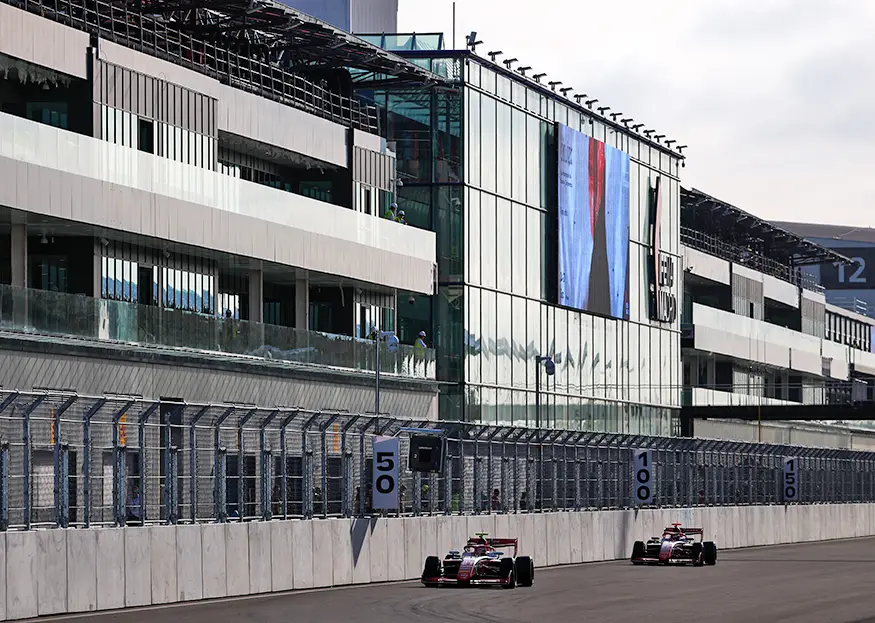 James Wharton's PREMA Racing car passes the grandstand under construction at Madring