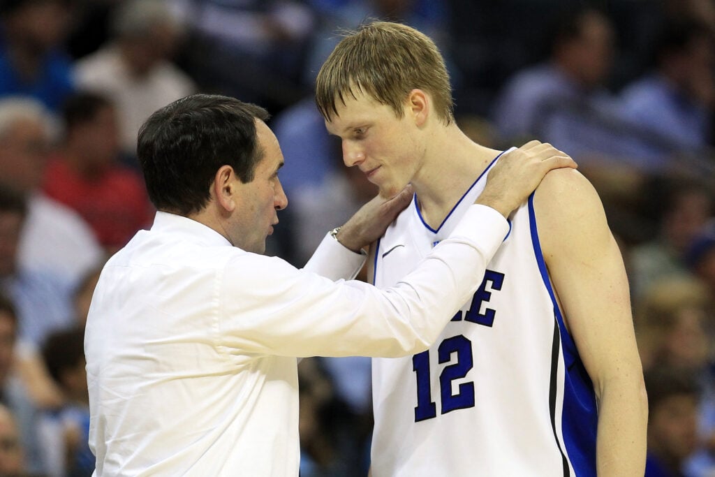 Head coach Mike Krzyzewski of the Duke Blue Devils talks with Kyle Singler #12 while taking on the Michigan Wolverines during the third round of the 2011 NCAA men's basketball tournament at Time Warner Cable Arena on March 20, 2011 in Charlotte, North Carolina.