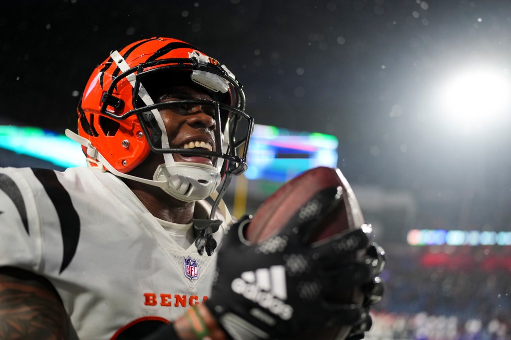 Cam Taylor-Britt celebrates recording the game-sealing interception against the Buffalo Bills during the Divisional Round of the 2022-23 NFL Playoffs. 