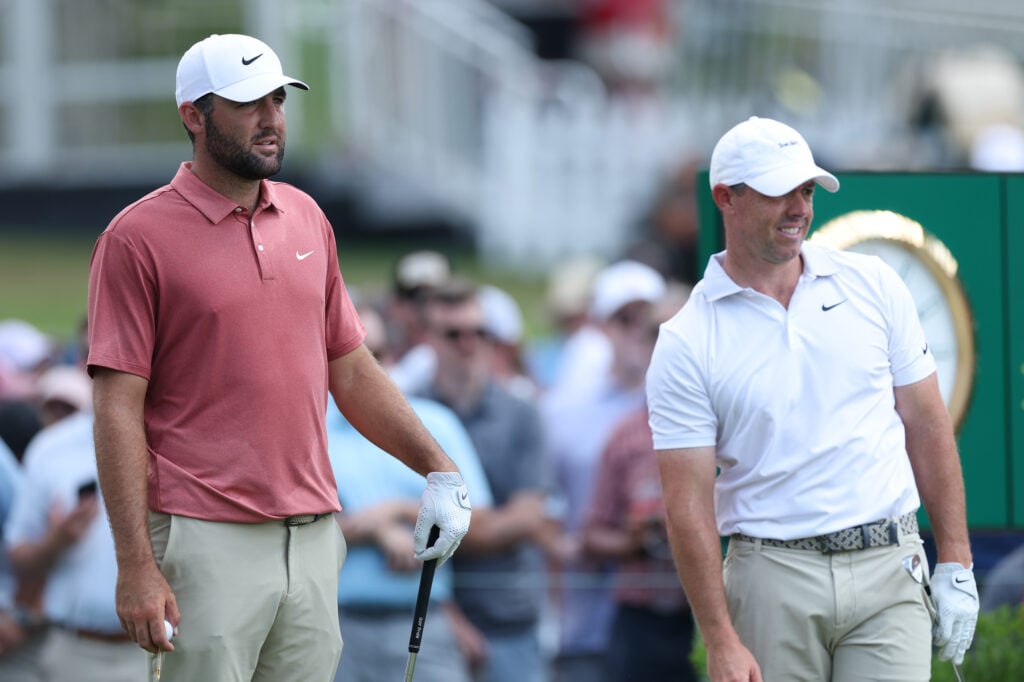 Scottie Scheffler and Rory McIlroy watch on from the ninth tee during the first round of the Tour Championship
