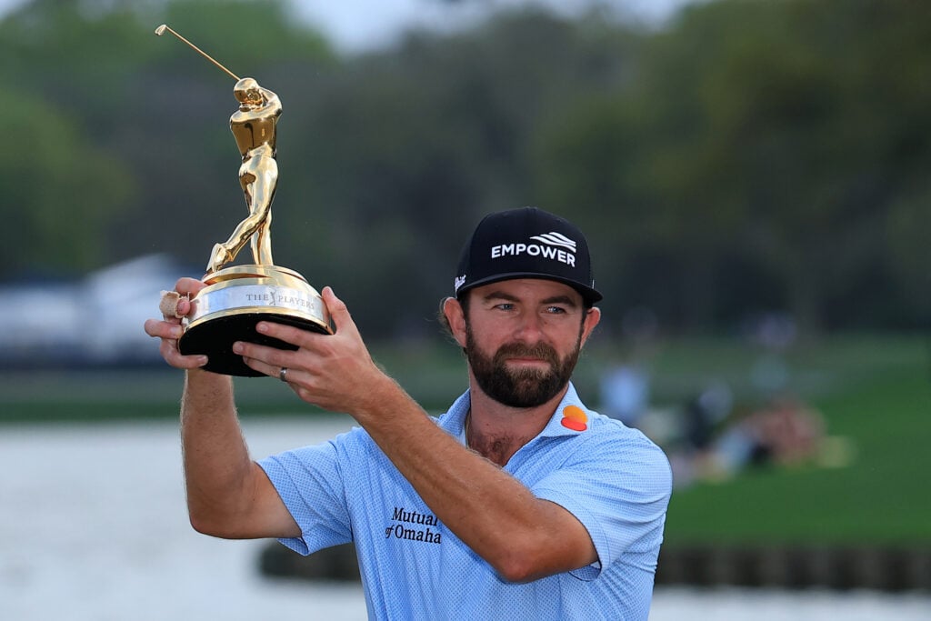Cameron Young of the United States holds the trophy aloft following his victory during the final round of THE PLAYERS Championship 2026