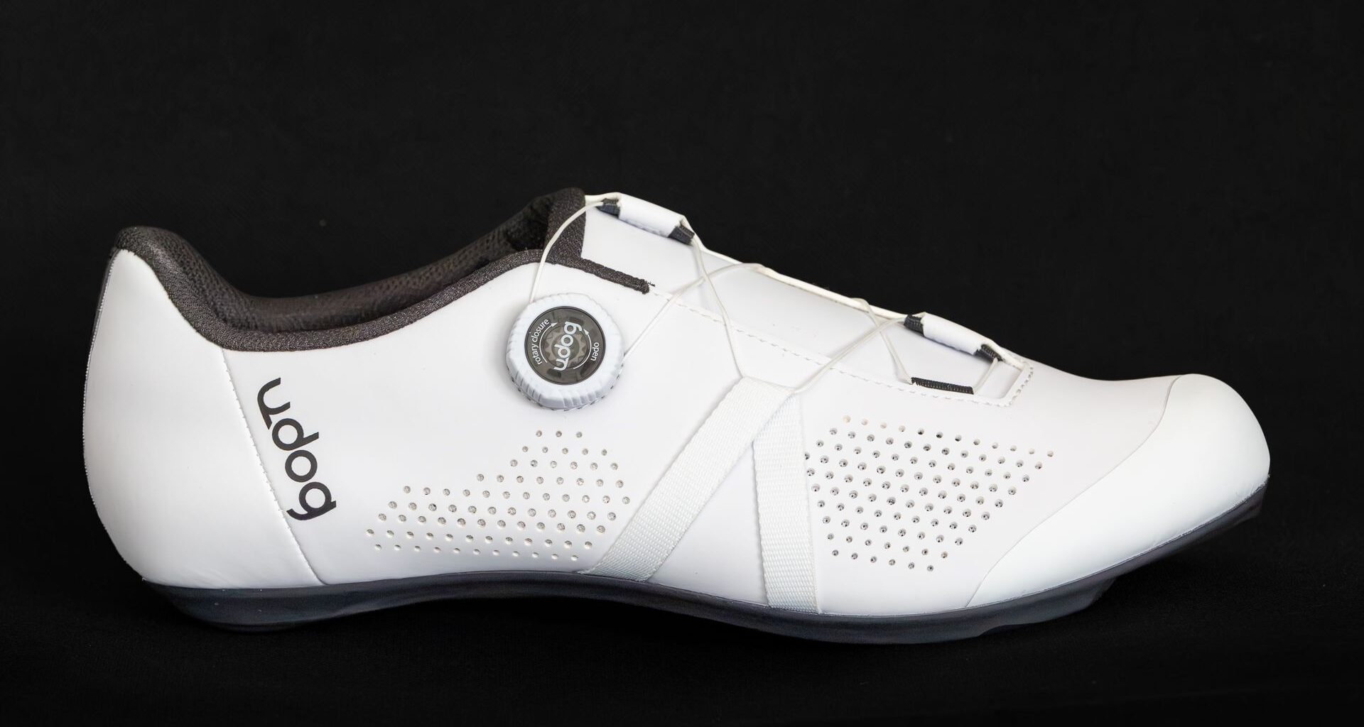 White road cycling shoe side on against a black background
