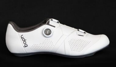 White road cycling shoe side on against a black background