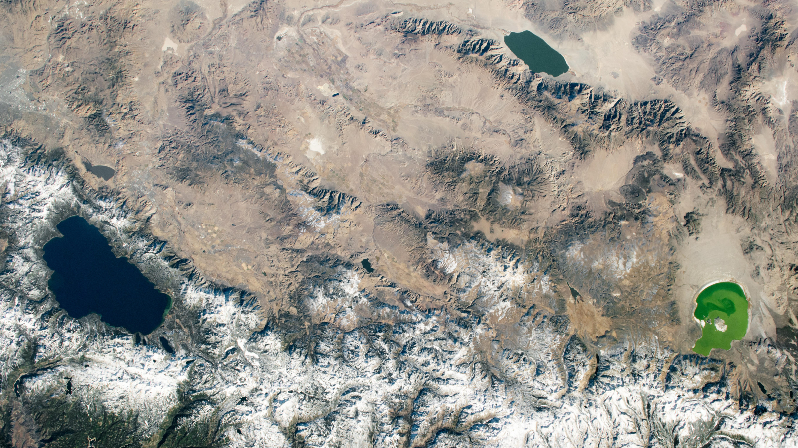 An astronaut photo showing three differently colored lakes in a triangle
