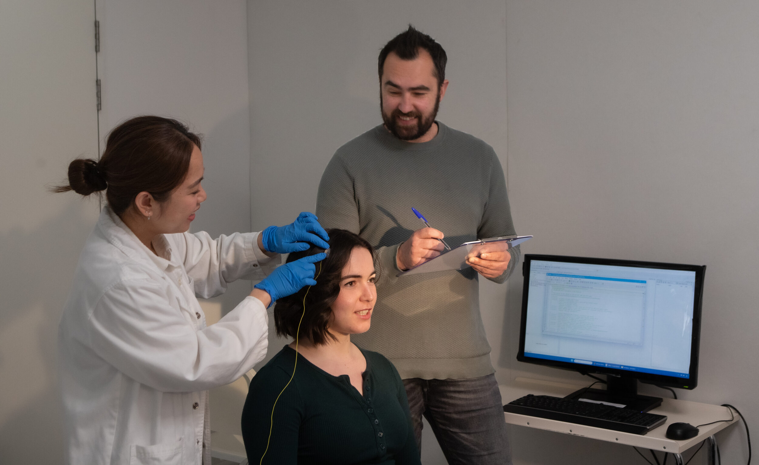 Trish Emperado, PGDipMedTech, Monash University's Edwards Lab manager and project coordinator and Brad Edwards, PhD, director of the Sleep & Circadian Rhythm Research Program and Head of Sleep Disorders Research Laboratory at Monash University, attach electrodes to the scalp of Georgina Rawson, a PhD Candidate in the Edwards Lab.