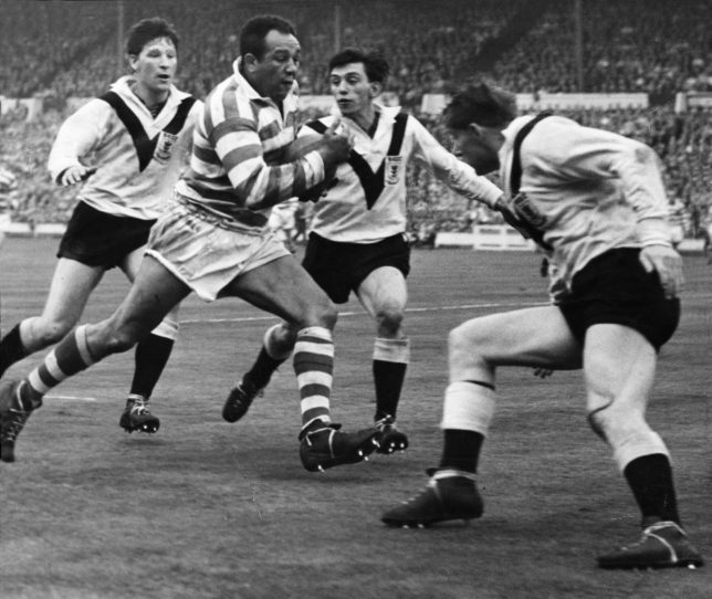 Action during the Rugby League clash between Wigan and Hull during the Challenge Cup Final at Wembley Stadium. Picture shows: Three men team up to stop Wigan player Billy Boston as he tries to bulldoze his way through to Hull's try line. Wigan went on to win 30 - 13 with Boston scoring two tries, 9th May 1959. (Photo by Charlie Ley/Mirrorpix/Getty Images)