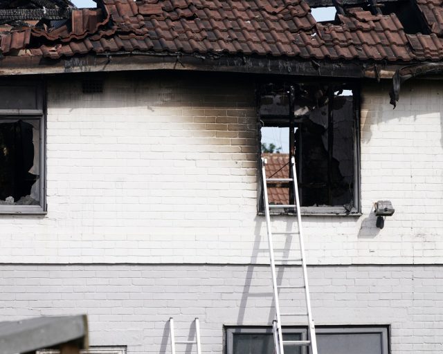 MIDDLESBROUGH, ENGLAND - AUGUST 26: Extensive damage is seen at the scene of a house fire on August 26, 2026 in Middlesbrough, England. Cleveland Police have launched a murder investigation after a fatal house fire in Grangetown, Middlesbrough, left two people dead and four others hospitalised in the early hours of Wednesday, 26 August 2026. Investigators have stated they are keeping an open mind and cannot rule out links to wider organised crime. (Photo by Ian Forsyth/Getty Images)