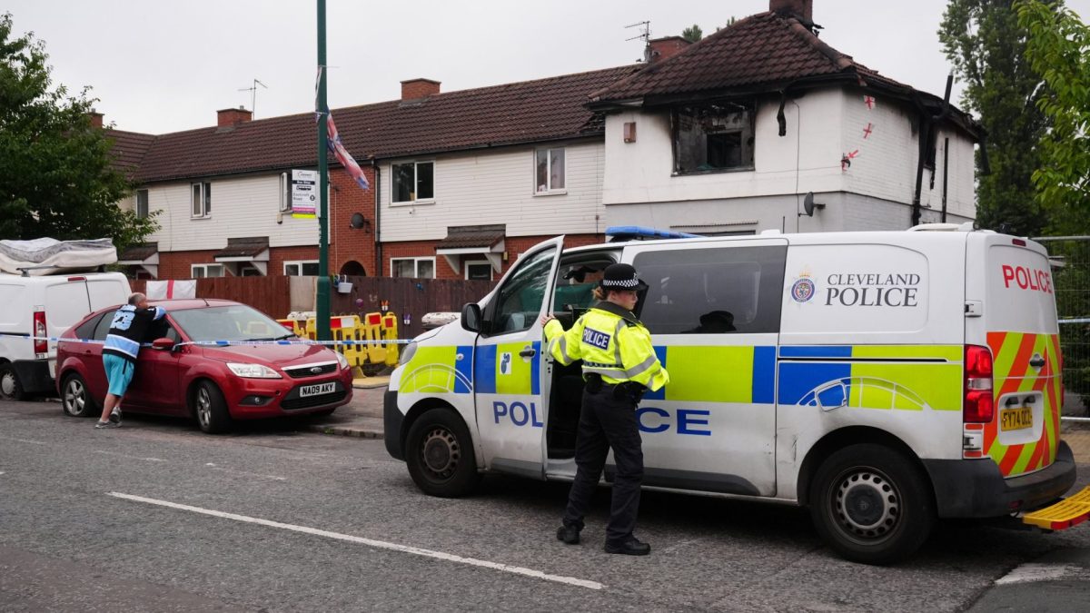 Police officers at the scene on Birchington Avenue, Grangetown, near Middlesbrough, where Valentina Foster, aged seven, and Natalie McDonald, 34, died following a fire at an end-of-terrace property on Wednesday morning. Police are not ruling out a possible link between the fatal house fire and a crash on the A66 less than two miles away that killed seven people. Picture date: Thursday August 27, 2026. PA Photo. Cleveland Police said two men, aged 23 and 31, have been arrested on suspicion of murder and they remain in police custody following the fire. Photo credit should read: Owen Humphreys/PA Wire