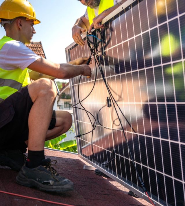 Service engineer checking solar cell on the roof for maintenance if there is a damaged part