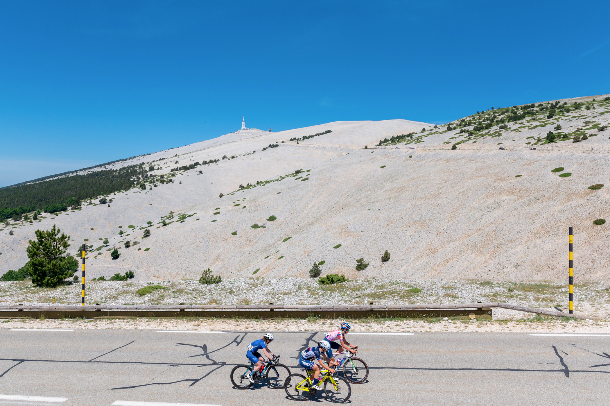 MONT VENTOUX, BEDOIN, VAUCLUSE, FRANCE - 2022/06/14: (L-R) Ella Harris ( team Canyon Sram), Margaux Vigi&eacute; (Team France), Olivia Bent (team Awol O'shea) in action three kilometers from the finish line. The first edition of the Mont Ventoux D&eacute;nivel&eacute; Challenge Femmes (WE 1.2 category) took place between Vaison-la-Romaine and Mont Ventoux over a distance of 98 kilometers. The Italian Marta Cavalli (FDJ-Nouvelle Aquitaine-Futuroscope) covered the 98 km in 3h19mn01s ahead of Clara Koppenburg (Cofidis Women Team) who finished second and Evita Muzic (FDJ-Nouvelle Aquitaine-Futuroscope), third. (Photo by Laurent Coust/SOPA Images/LightRocket via Getty Images)