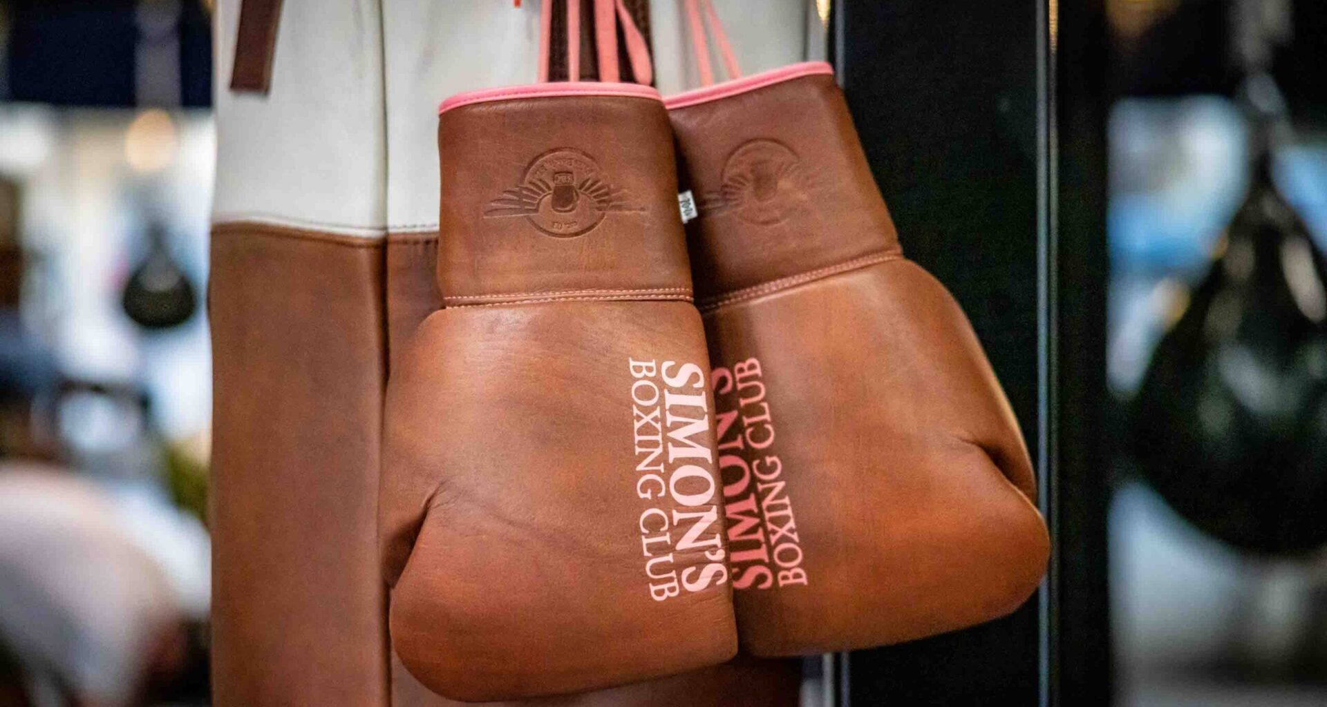 A pair of boxing gloves hang inside Simon s Boxing Club January 23, 2023. Simon "The Phoenix," Bakinde was born in Cameroon,