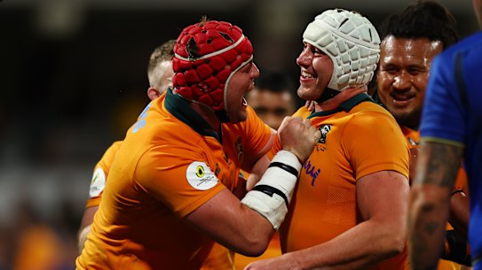 Josh Canham is mobbed after scoring a hat-trick against Italy in Perth.