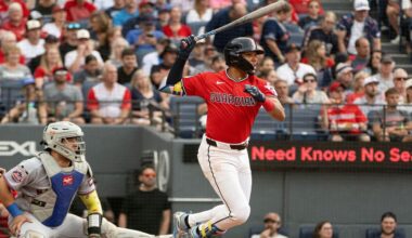 Cleveland Guardians' Angel Genao watches his single off New York Mets starting pitcher Christian Scott, his first Major League hit, as Francisco Alvarez looks on during the third inning of a baseball game, Wednesday, Aug. 5, 2026, in Cleveland. (AP Photo/Phil Long)