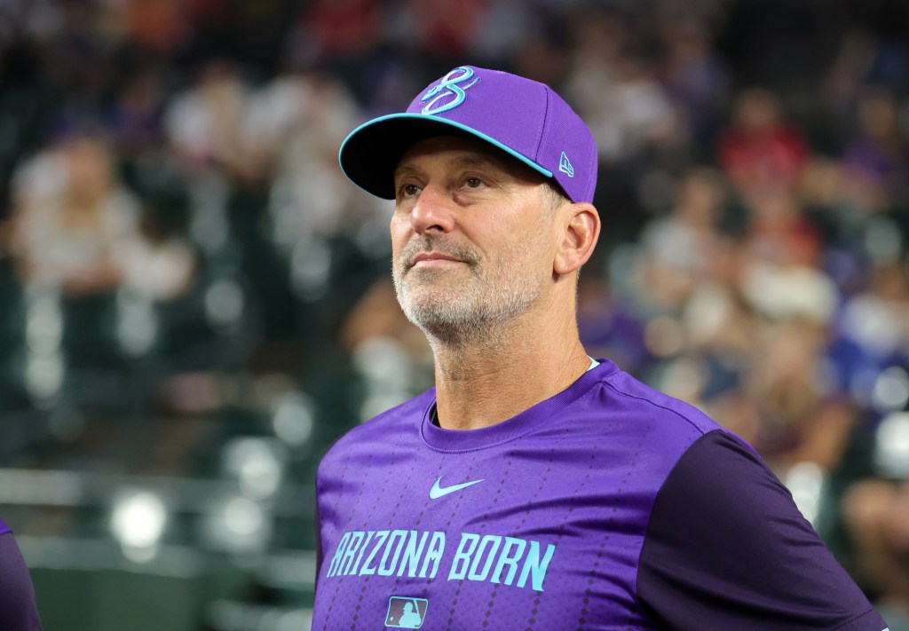 Arizona Diamondbacks manager Torey Lovullo in a purple cap and shirt, looking slightly to the right.