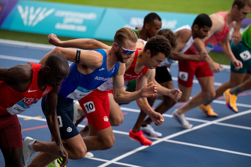 Athletes start off the blocks in a track race
