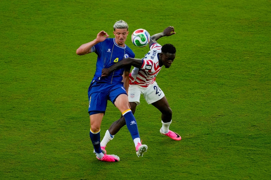Folarin Balogun's foot rests on Tarik Muharemović's ankle.