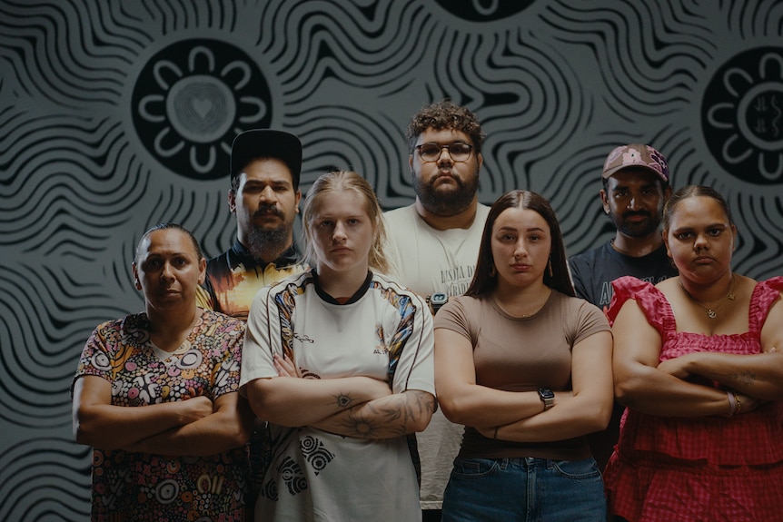 A group of young people stand staunch
