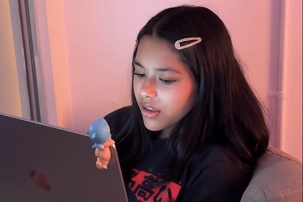 teenage singer songwriter Niko Karolia sits with a laptop 
