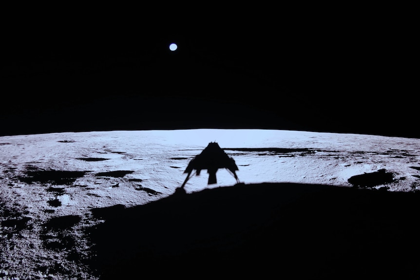 A shadow cast onto the Moon's surface of a lunar module, showing its shape (like a space invader) with legs on the surface.