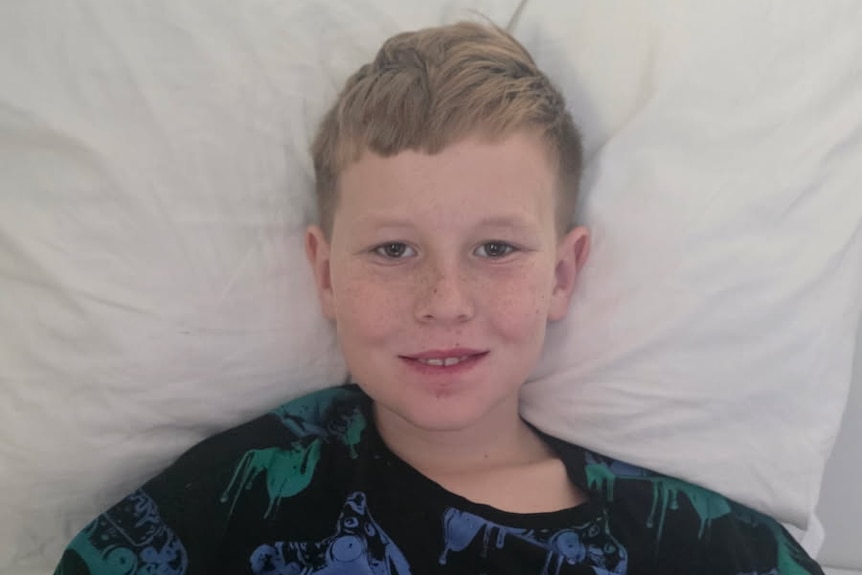 A 10-year-old boy in a hospital bed