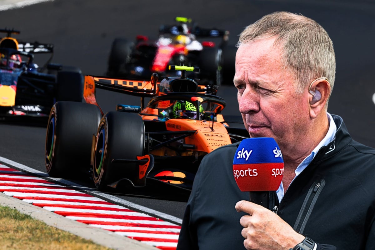Brundle holding Sky Sports mic looking over Ferrari, Red Bull and McLaren F1 cars on track