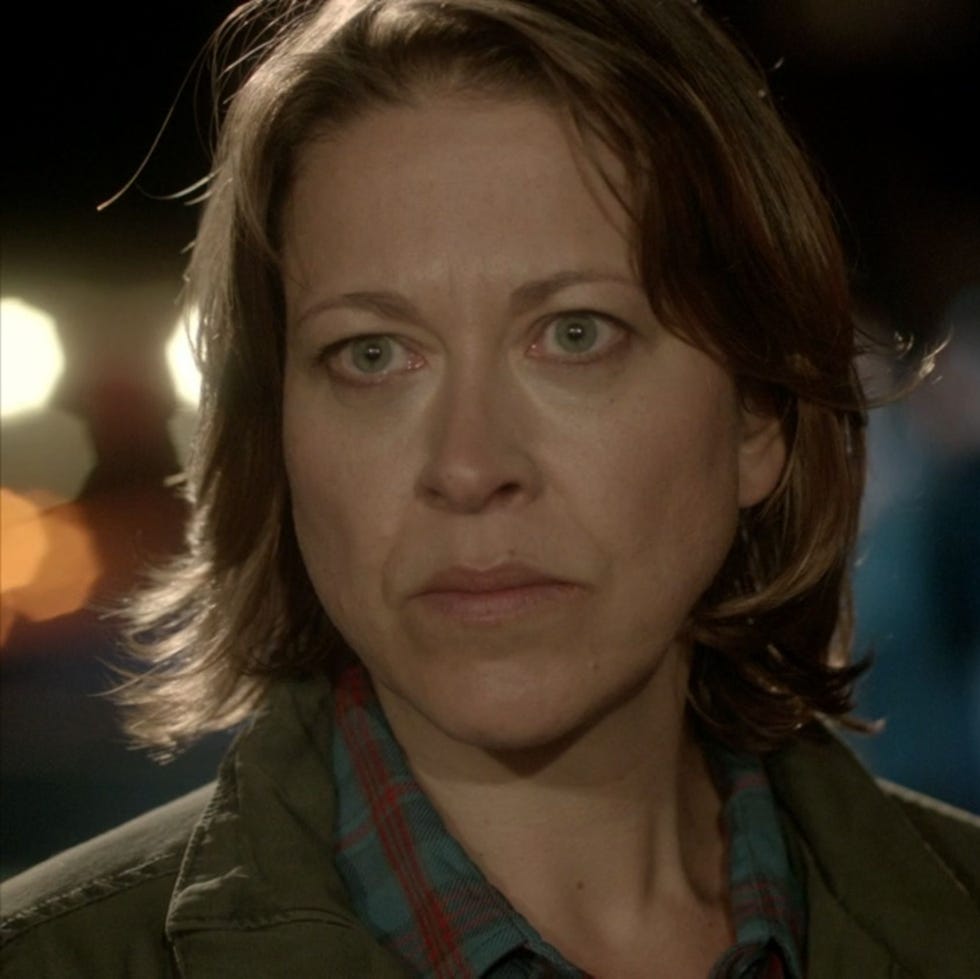 woman with short hair looking concerned at night. woman with short hair looking concerned at night.