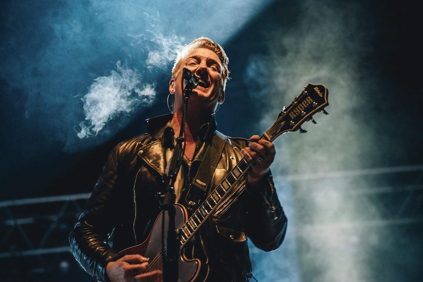 close up image of josh homme on stage performing at splendour in the grass 2107