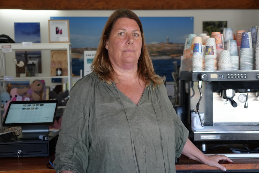 Lady standing next to coffee machine