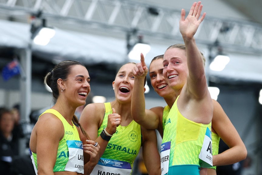 Australia's 4x100m relay team celebrate after their heat run at the Commonwealth Games.