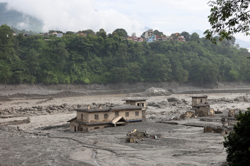 buildings partially emerge from deep grey sedament