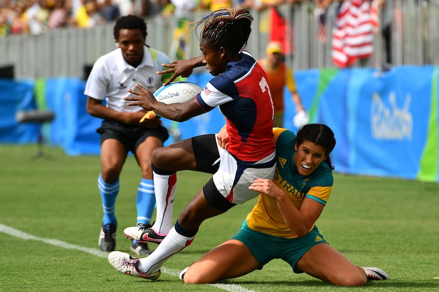 Victoria Folayan of the United States is tackled into touch by Charlotte Caslick of Australia at 2016 Olympics.
